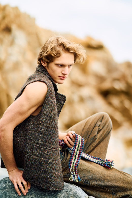Man wearing a brown flecked Irish tweed gilet, handcrafted with premium Irish textiles and featuring front pockets.