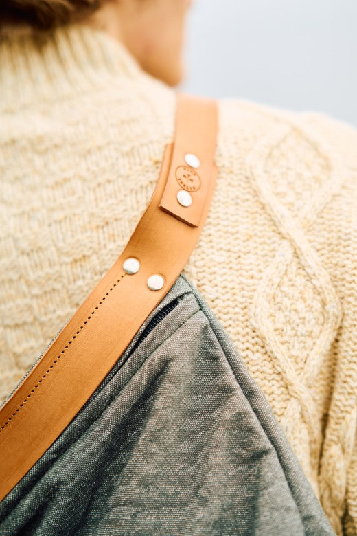 Grey canvas and tan leather crossbody bag handmade by Mark Ingles, featuring durable materials and a spacious design.