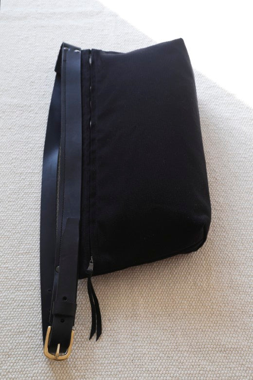 Black canvas and leather crossbody bag handmade by Mark Ingles, featuring durable deadstock fabric and adjustable straps.