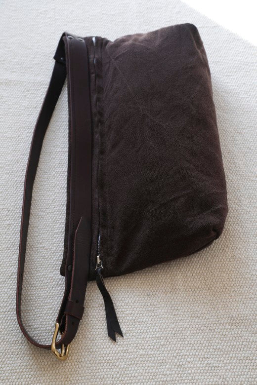 Dark brown canvas and leather crossbody bag handmade by Mark Ingles, featuring durable straps and a zip closure.
