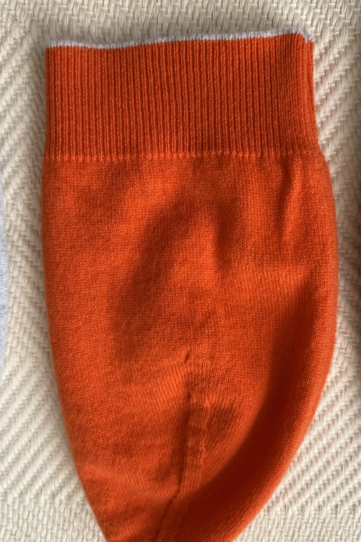 Vibrant orange 100% cashmere beanie, expertly crafted in Ireland with a signature ribbed trim and soft, high-quality knit.