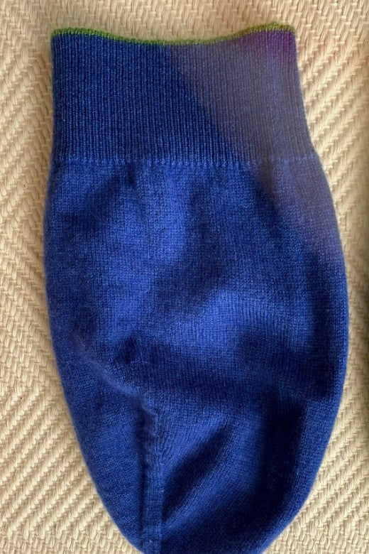 Luxurious blue 100% cashmere beanie with green trim, expertly crafted in Ireland for a soft, premium fit.