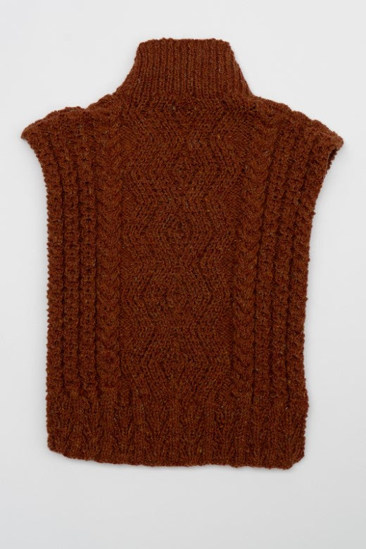 Rust-colored handknit Aran cable bib, crafted in Donegal with high-quality wool featuring intricate diamond patterns.