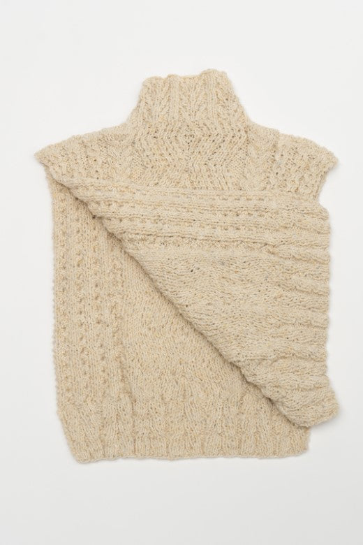 Hand-knit cream Aran cable body bib, crafted in Donegal with high-quality Irish wool featuring intricate textured patterns.