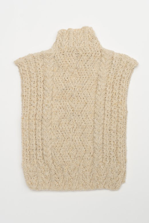 Cream-colored handknit Aran cable body bib, crafted in Ireland with traditional textures and high-quality wool by artisan Muriel.