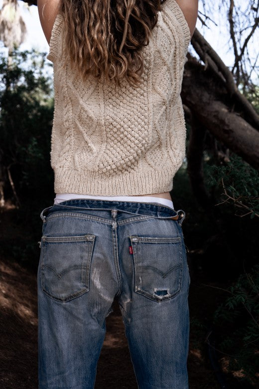 Hand-knitted cream Aran vest in soft Donegal merino wool, crafted by Irish makers for a traditional, textured look.