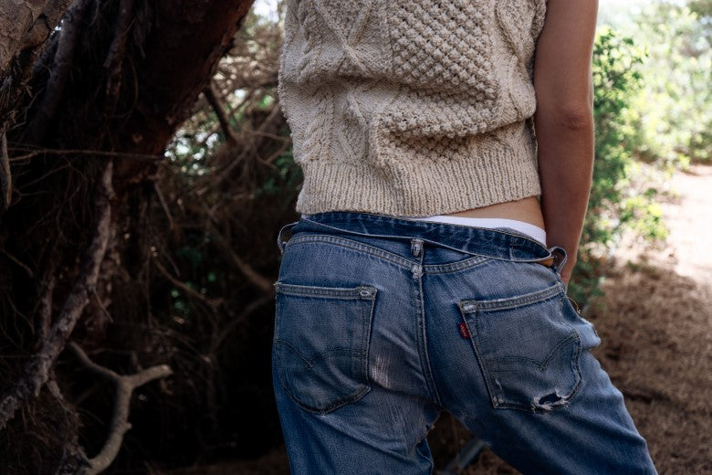 Hand-knitted cream merino wool Aran sleeveless vest, crafted in Ireland with traditional textured cable stitches.