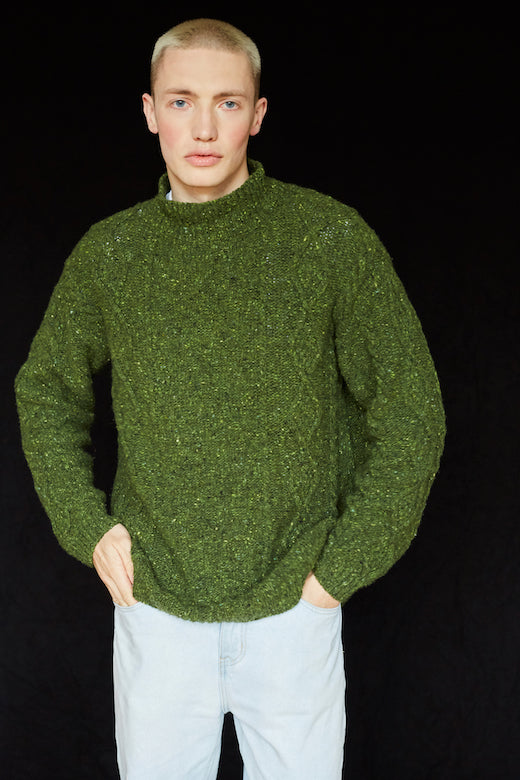 Moss green merino wool Donegal Aran jumper with traditional cable stitching, handcrafted by Irish artisans.