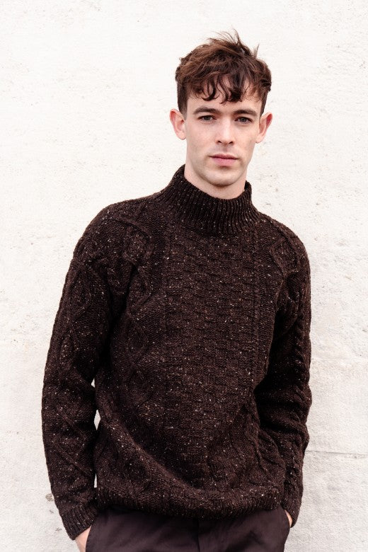 Unisex turf brown merino wool Aran jumper featuring traditional cable stitches, handcrafted by Irish artisans.