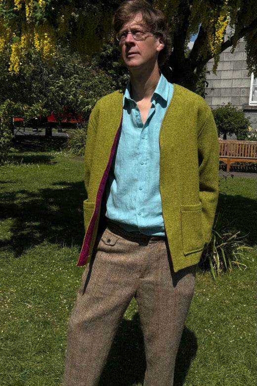 Handmade Irish Báinín tweed jacket in lime green with purple linen lining, crafted by Dublin makers using quality textiles.