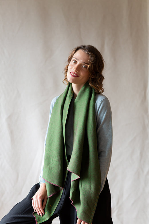 Model wearing a moss green STABLE Irish linen scarf, handcrafted from sustainable, high-quality Irish textiles.