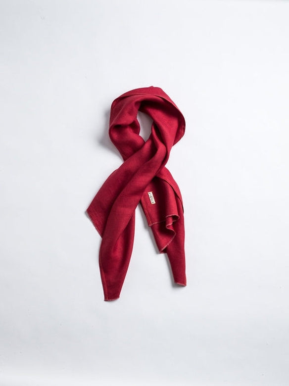 Red Irish linen scarf handcrafted by local makers, featuring a soft, textural weave and a signature STABLE brand label.