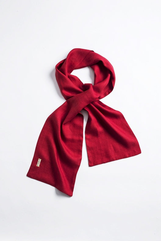 Vibrant red Irish linen scarf, handcrafted by Irish makers with high-quality sustainable flax, featuring a STABLE brand tag.