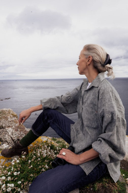 Sophie Darlington wearing a loose-fit grey Irish linen work shirt, crafted by Irish makers for functional outdoor wear.