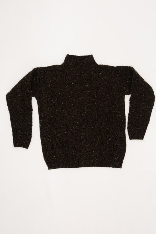 Turf brown Donegal merino wool Aran jumper featuring traditional cable and basketweave stitches, handcrafted in Ireland.
