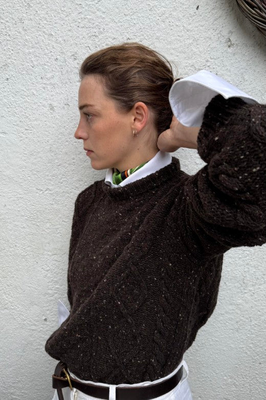 Turf brown merino wool Donegal Aran jumper with traditional cable knit, handcrafted by Irish artisans for a relaxed fit.
