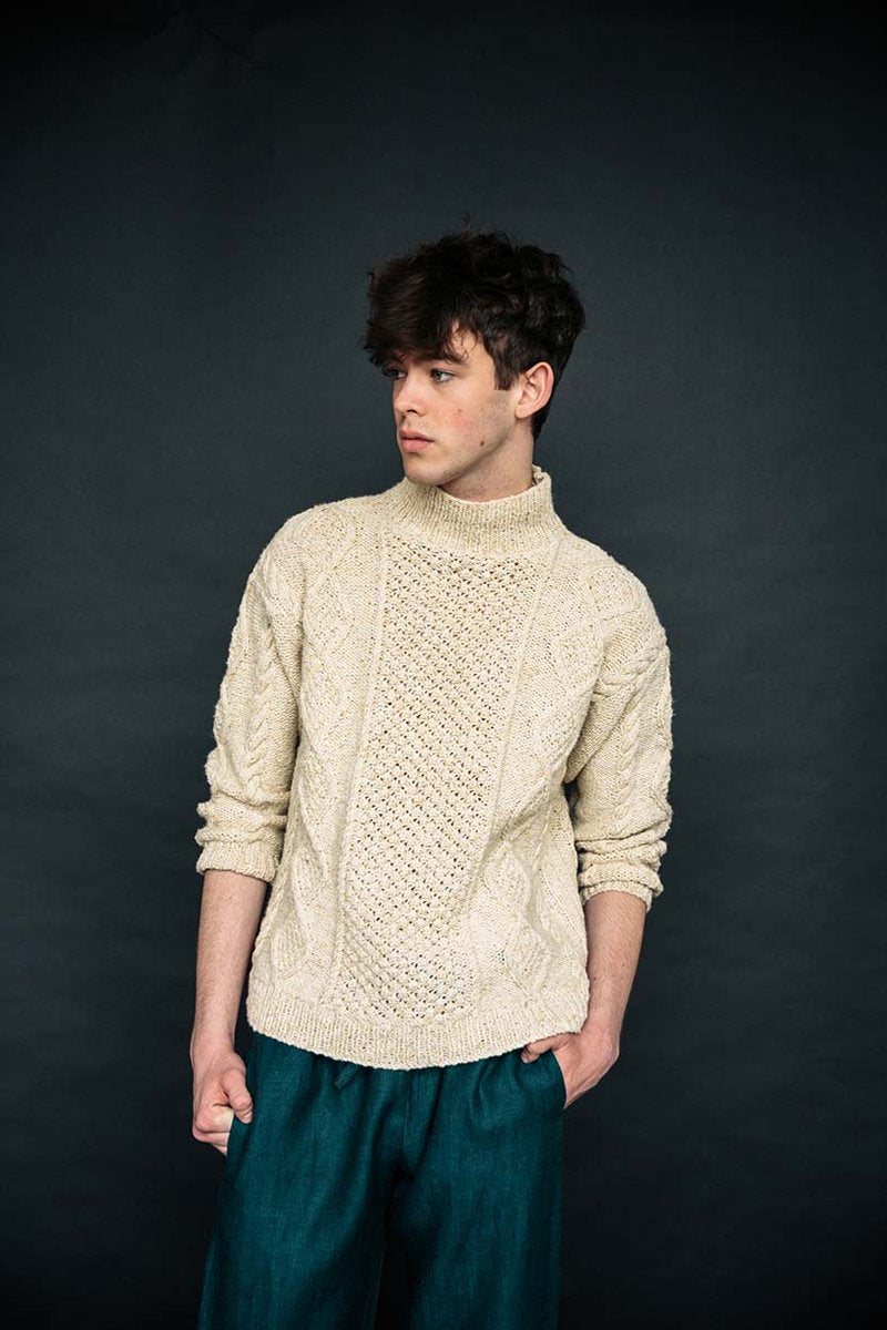 Cream merino wool handknit Aran jumper with blackberry stitch, crafted by Irish artisans for a relaxed, high-quality fit.