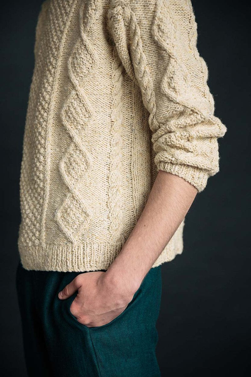 Cream merino wool Aran jumper hand-knit in Ireland featuring intricate blackberry and cable stitch patterns.