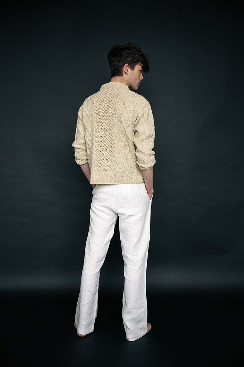 Cream merino wool handknit Aran jumper with blackberry stitch detail, crafted by Irish artisans for a relaxed, luxury fit.