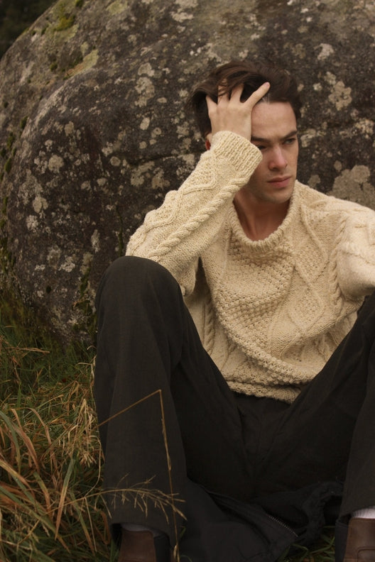 Cream merino wool Aran jumper with traditional blackberry stitch, hand-knit by Irish artisans in a relaxed fit.