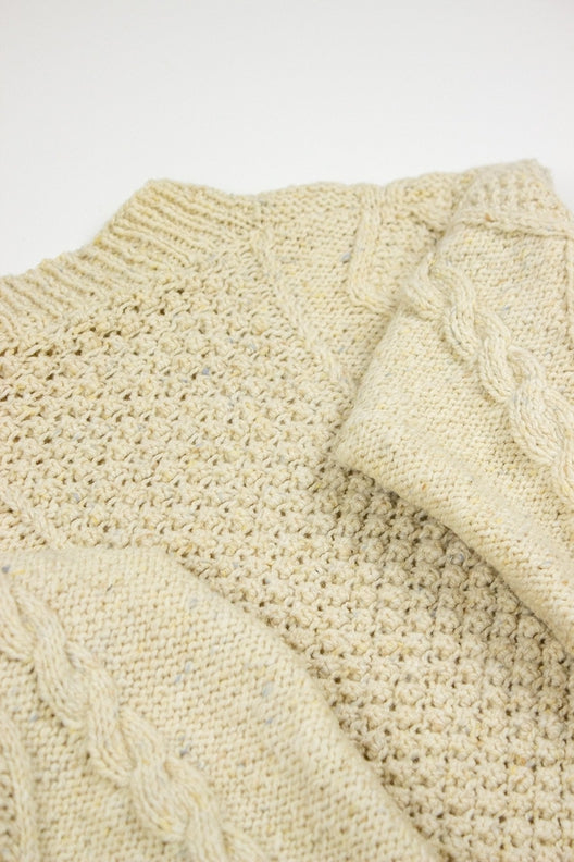Cream merino wool handknit Aran jumper featuring traditional blackberry and cable stitch patterns by Irish makers.