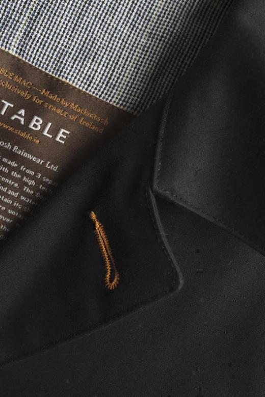 Ink black Mackintosh raincoat with detailed stitching, crafted in Ireland from high-quality bonded cotton fabric.