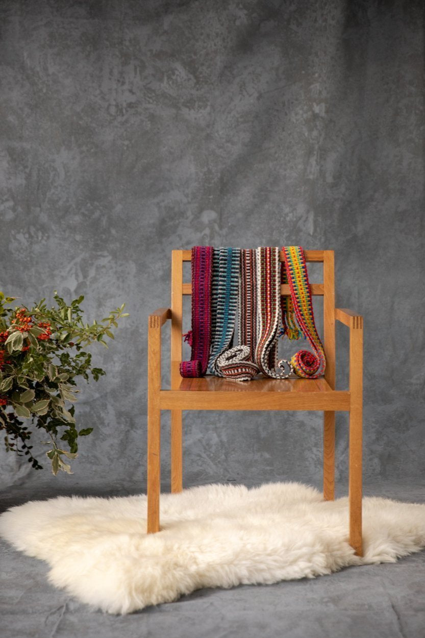 Luxurious, soft blush Irish sheepskin rug draped over a wooden chair, handcrafted by local artisans in the Irish countryside.