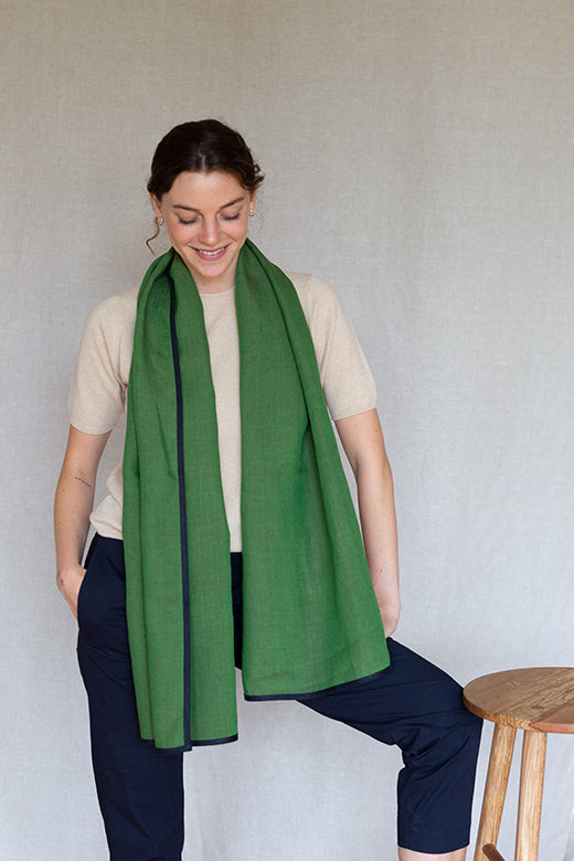 Moss green Irish linen scarf with navy trim, handcrafted by Irish makers from high-quality, sustainable natural fibers.