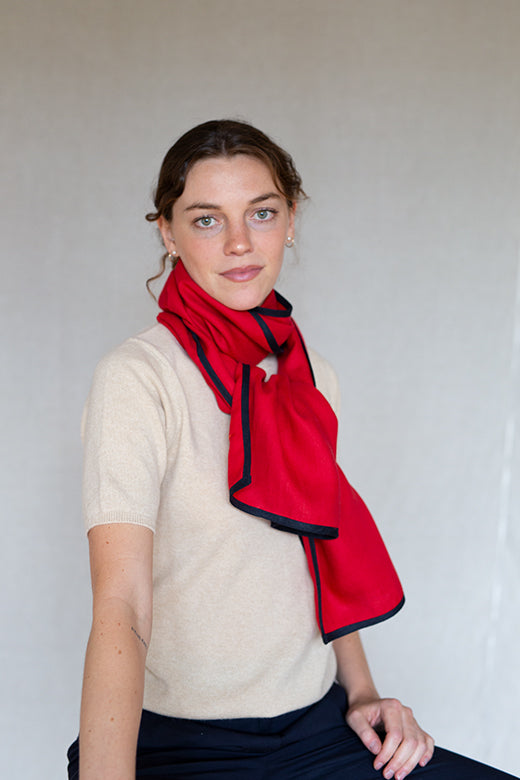 Red Irish linen scarf with navy trim, handcrafted by Irish makers from high-quality, sustainable natural fibers.