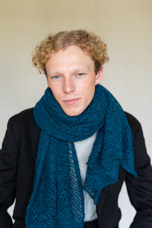Teal blue alpaca knit scarf featuring intricate Irish lace patterns, handcrafted by Marian for a soft, durable finish.