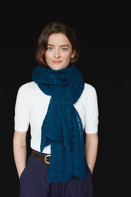 Teal blue alpaca lace scarf, hand-knitted in Ireland by Marian, featuring intricate Aran-inspired patterns.