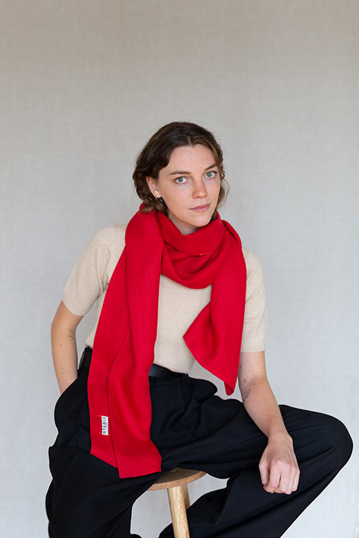 Vibrant red Irish linen scarf handcrafted by Irish makers, featuring a soft, high-quality textile and a STABLE brand label.