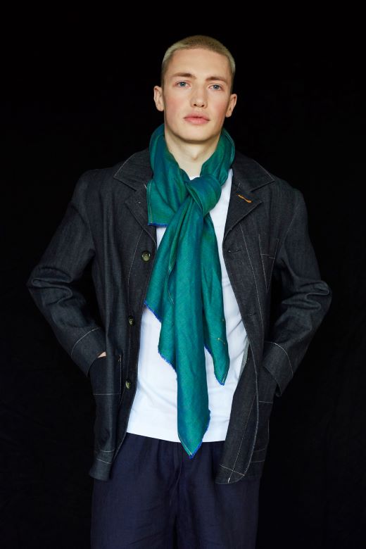 Model wearing a soft, sea green Irish linen scarf, handcrafted by Irish makers from high-quality, sustainable flax.