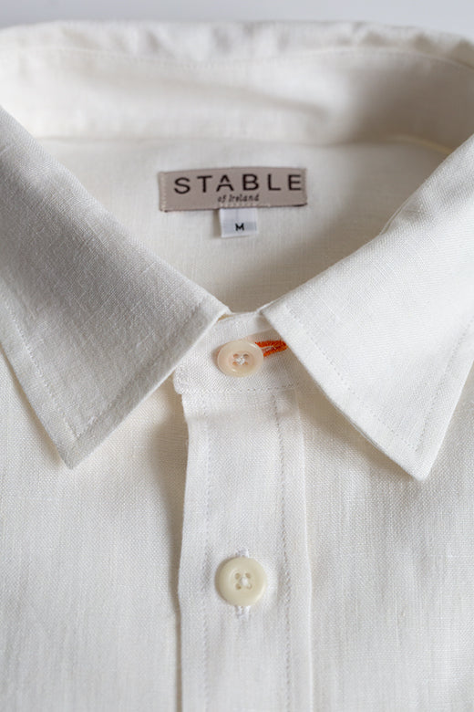 White Irish linen shirt in size M, featuring a stiffened collar, signature orange stitch buttonhole, and premium woven fabric.